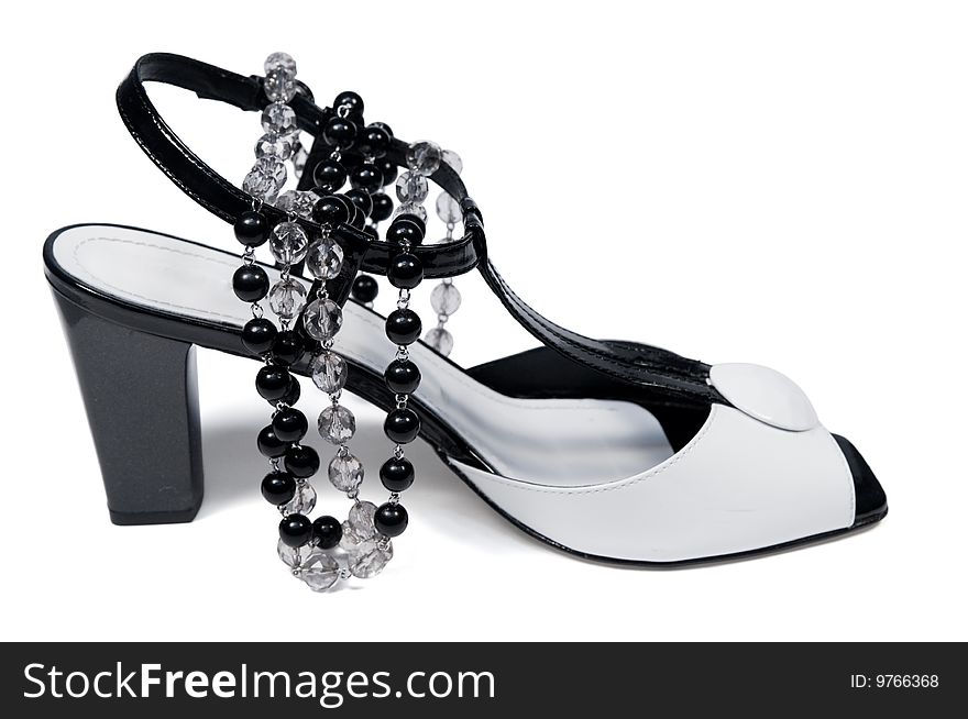 Womanish summer shoe and necklace is isolated on a white background