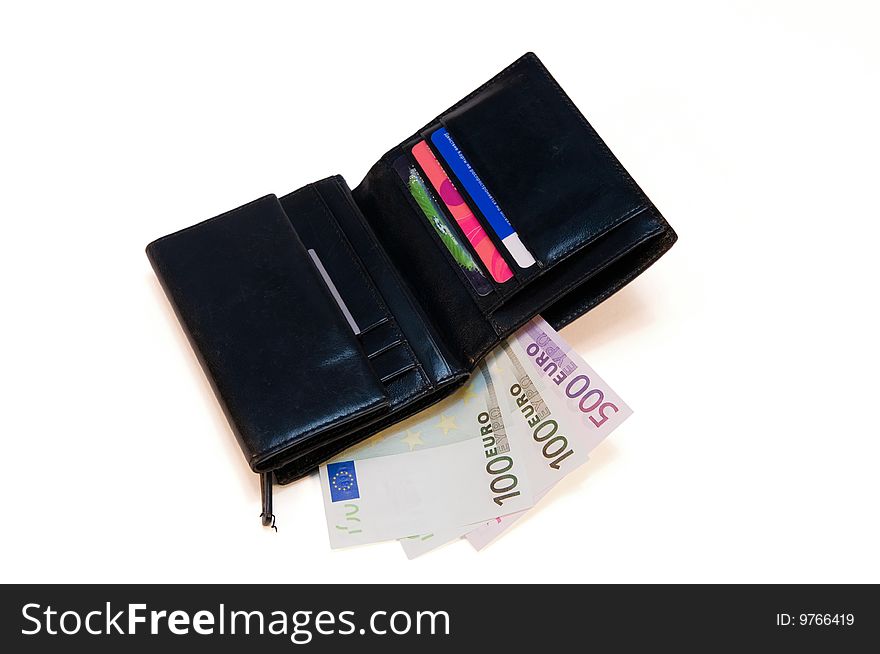 Black leather purse with money and credit cards on a white background