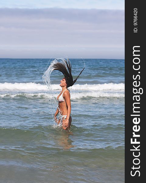 Girl with long hair in the sea