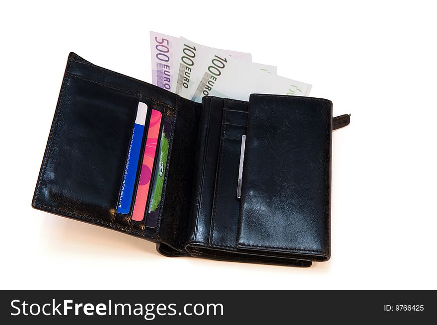 Black leather purse with money and credit cards on a white background