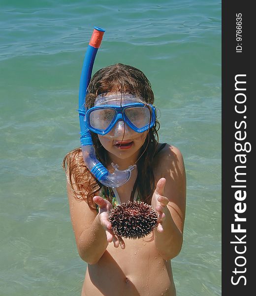 Sea, girl with diving mask take with hands sea urchin. Sea, girl with diving mask take with hands sea urchin.