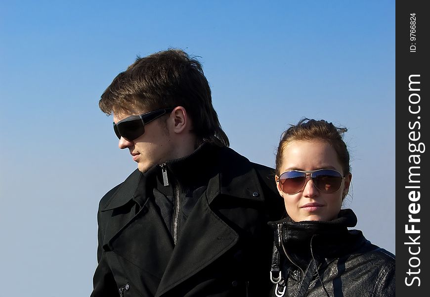 Young couple in the black jacket and sunglasses