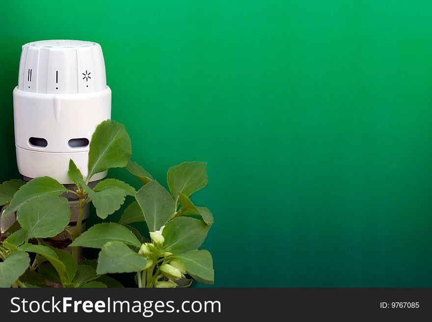 Radiator thermostat with green graduated background and plants. Radiator thermostat with green graduated background and plants
