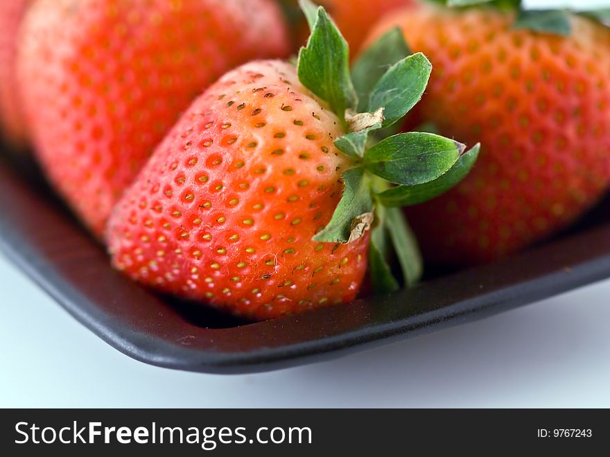 Strawberries in a black plate. Strawberries in a black plate