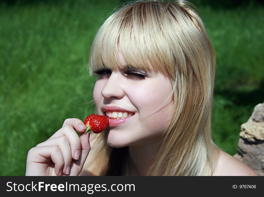 Blonde girl eating delicious strawberry. Blonde girl eating delicious strawberry