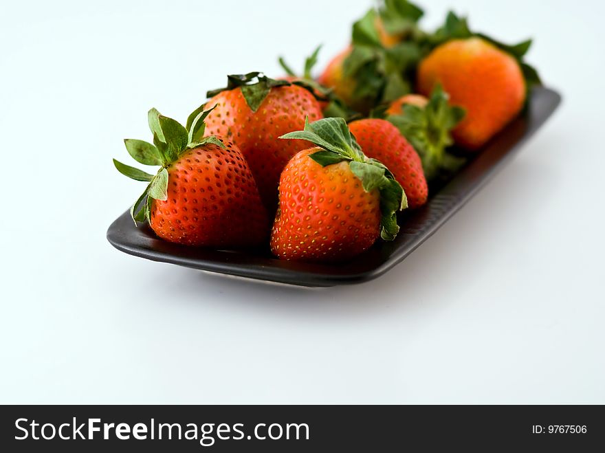 Strawberries in a black plate. Strawberries in a black plate