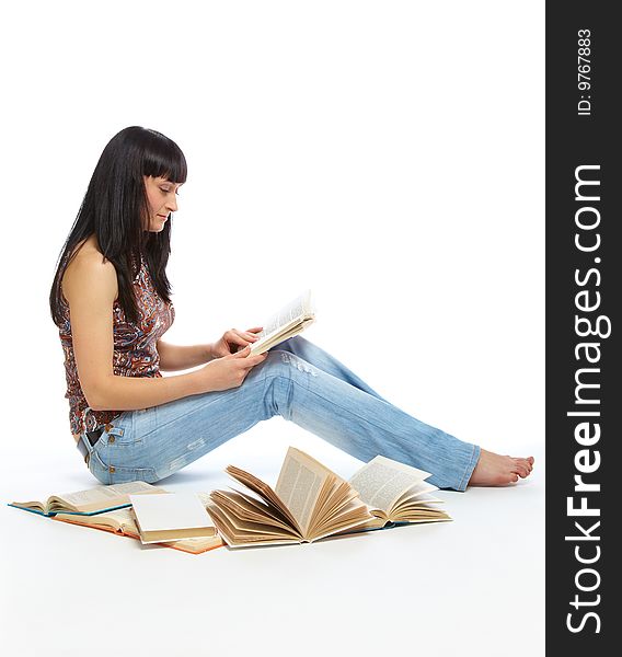 Girl Sitting On The Floor And Reading Book