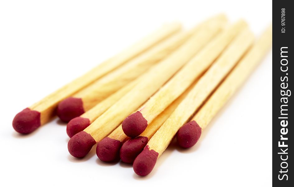 Several red matches on white background