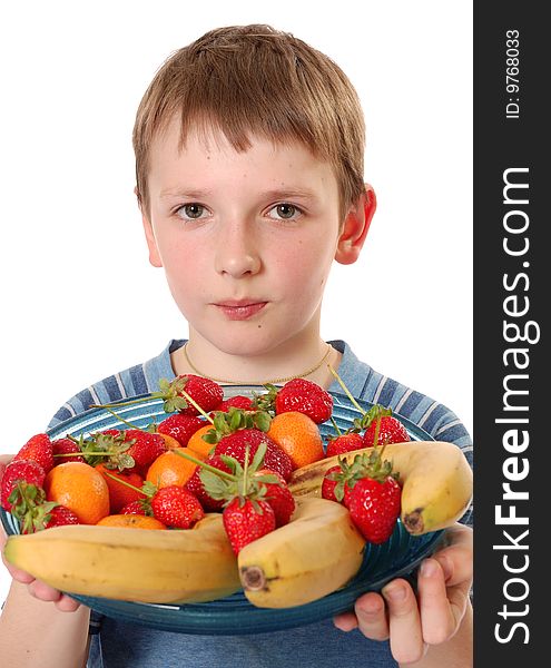Beautiful boy showing the plate with fruits isolated on white. Beautiful boy showing the plate with fruits isolated on white.
