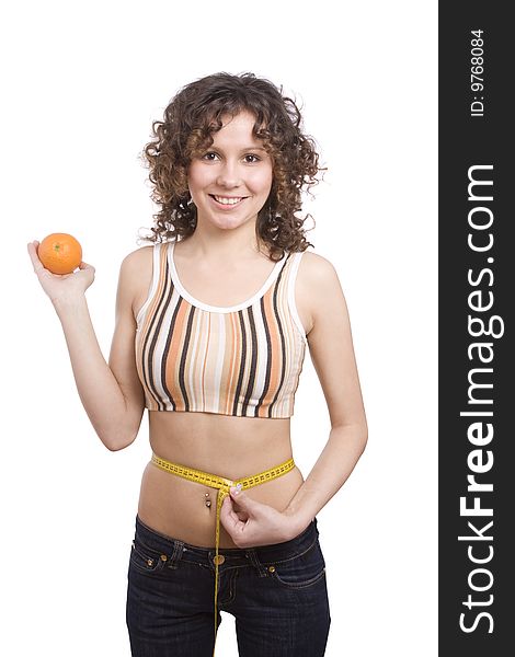 Beautiful fit woman with measure tape isolated over white. Weight loss and healthy lifestyle concept. Girl measuring waist with a tape measure. Isolated. Woman hold orange in hand. Waist is 65.5 centimeters. Beautiful fit woman with measure tape isolated over white. Weight loss and healthy lifestyle concept. Girl measuring waist with a tape measure. Isolated. Woman hold orange in hand. Waist is 65.5 centimeters.