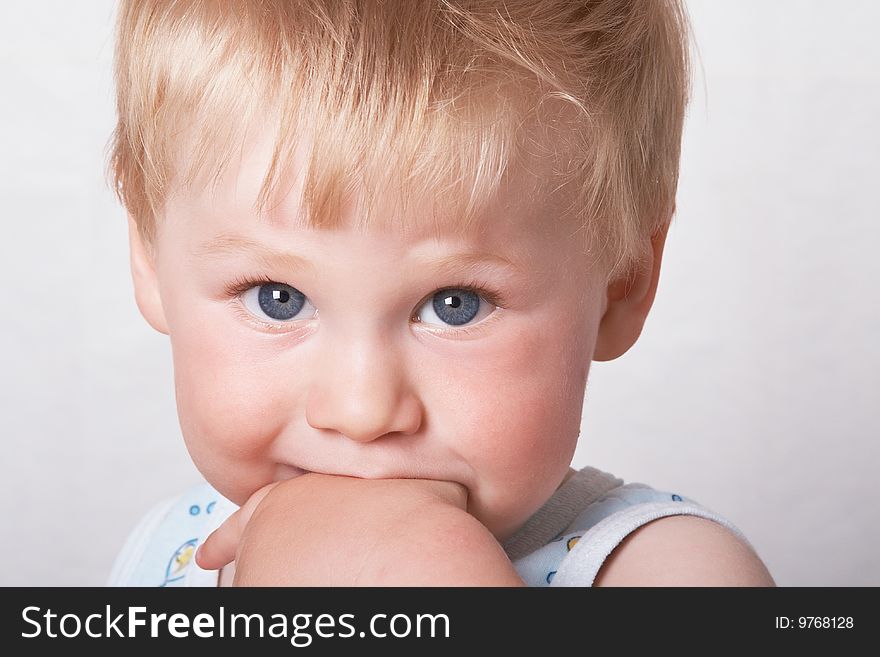 Portrait of the blond little boy on a background. Portrait of the blond little boy on a background