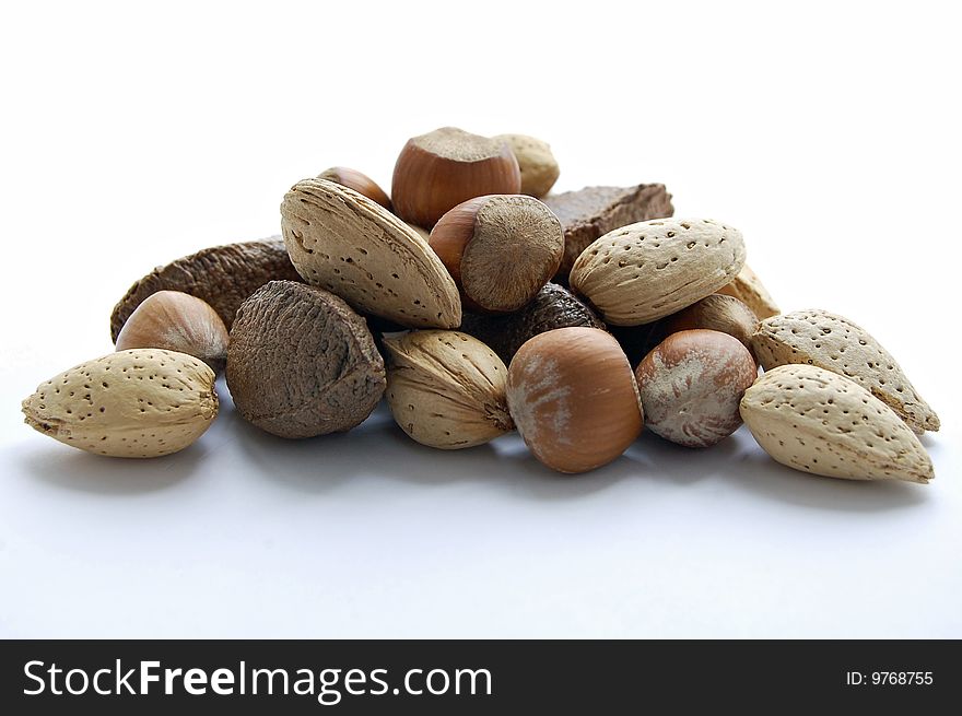 Several walnut and hazelnut on white background