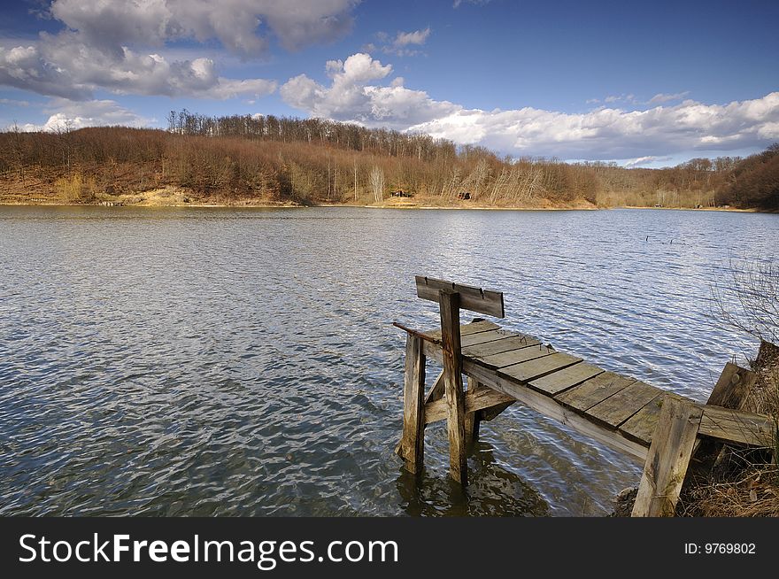 Early spring on the lake surrounded by wooded hills