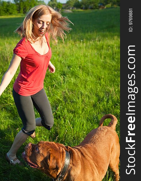 Young girl and her dog (French mastiff, Dogue de Bordeaux)