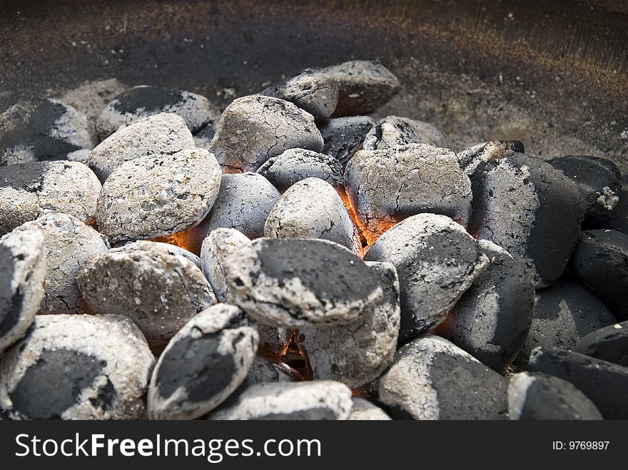 A hot barbecue grill with glowing coals.