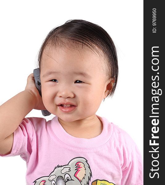 Chinese kid speak into cellphone with white background. Chinese kid speak into cellphone with white background