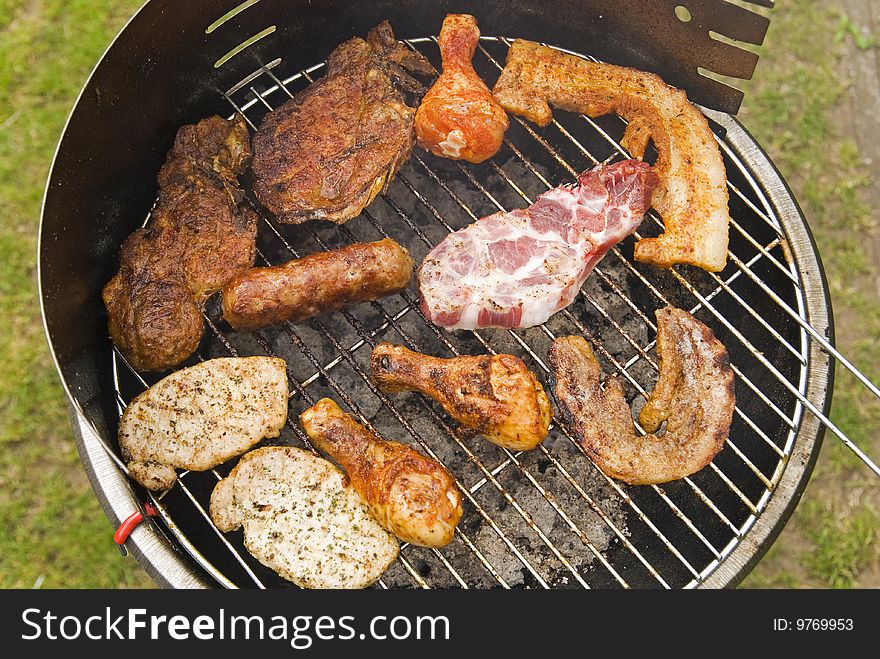 Sausages, hamburger and other meat on a barbecue. Sausages, hamburger and other meat on a barbecue
