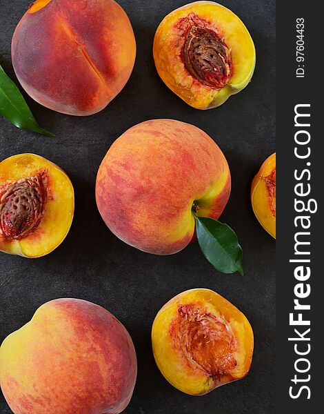 Fresh, Juicy Peaches On A Black Stone Background.