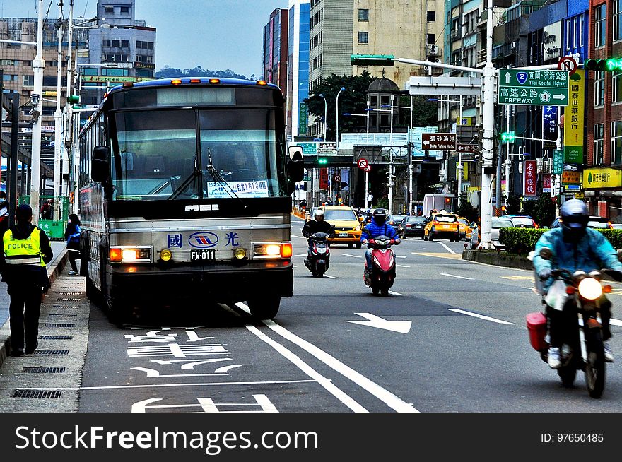 Busy street in Asia with bus and motorcycles.