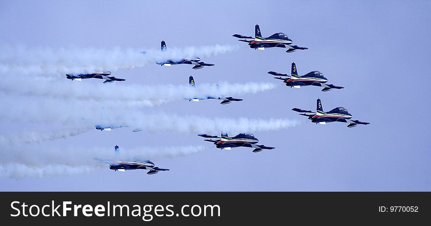 Aerobatic team of the Italian Air Force Frecce Tricolori (Three-coloured Arrows) on aircraft Aermacchi MB-339-A/PAN in flight. Aerobatic team of the Italian Air Force Frecce Tricolori (Three-coloured Arrows) on aircraft Aermacchi MB-339-A/PAN in flight.