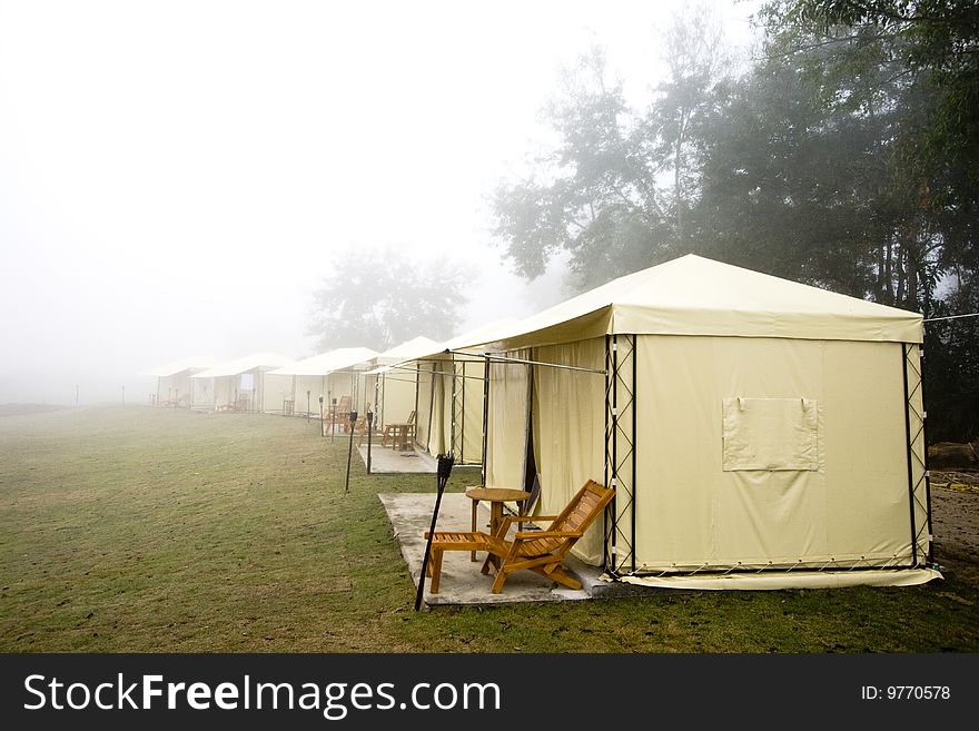 Yellow tent in foggy morning