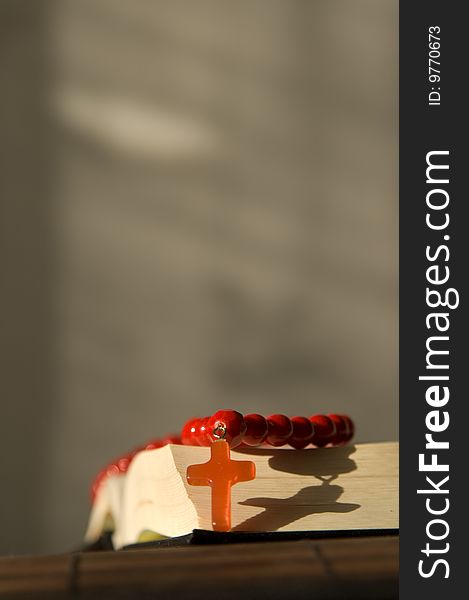 Book and red beads with cross. Book and red beads with cross