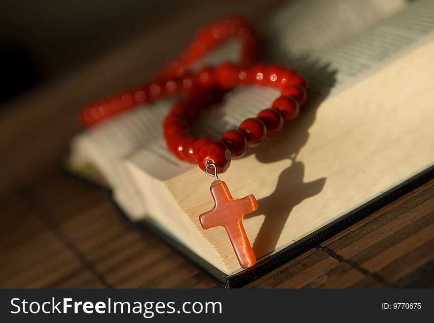 Book and red beads with cross. Book and red beads with cross