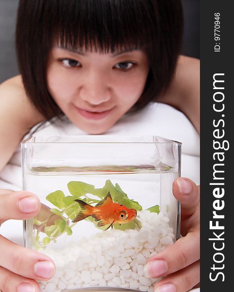 Asian girl with her goldfish