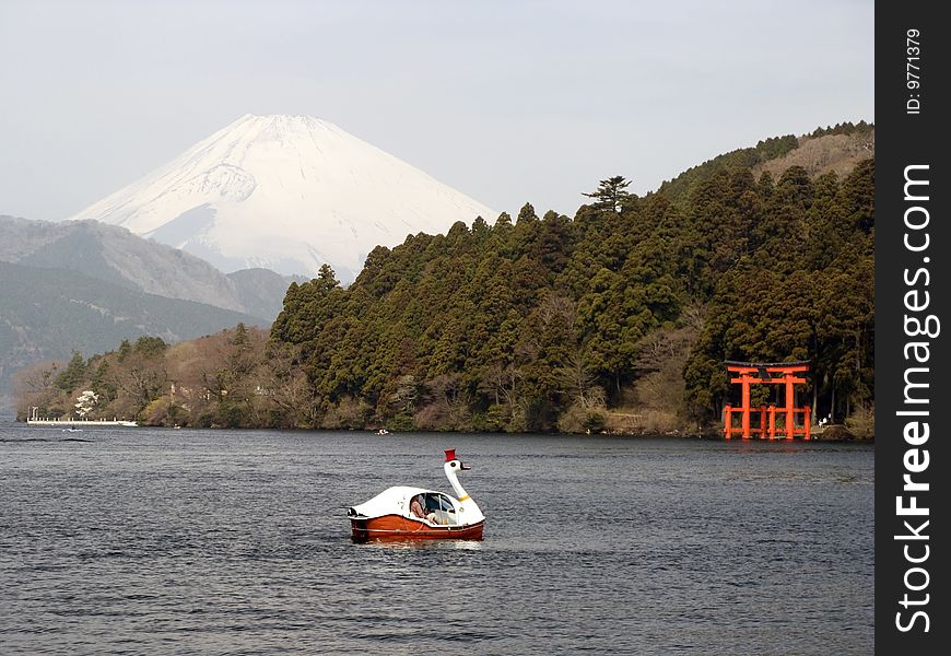 View of mount Fuji from Ashi lake, with a red gate. View of mount Fuji from Ashi lake, with a red gate