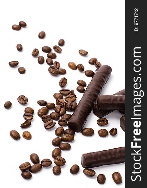 Chocolate bars and coffee beans on white background