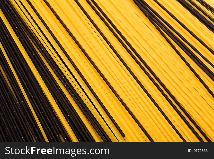 Black and yellow pasta close-up as a background