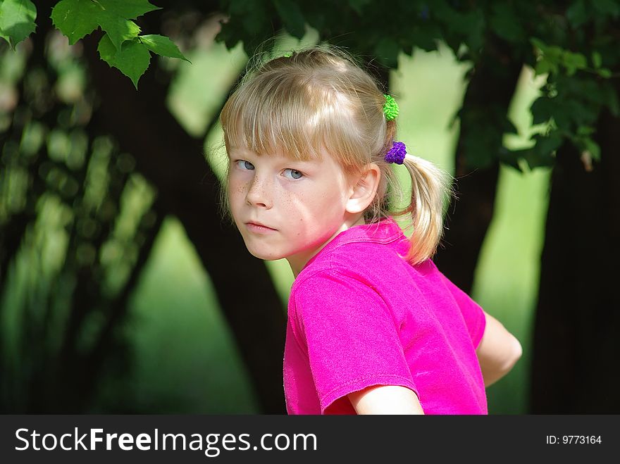 Girl in pink t-shirt outdoors. Girl in pink t-shirt outdoors