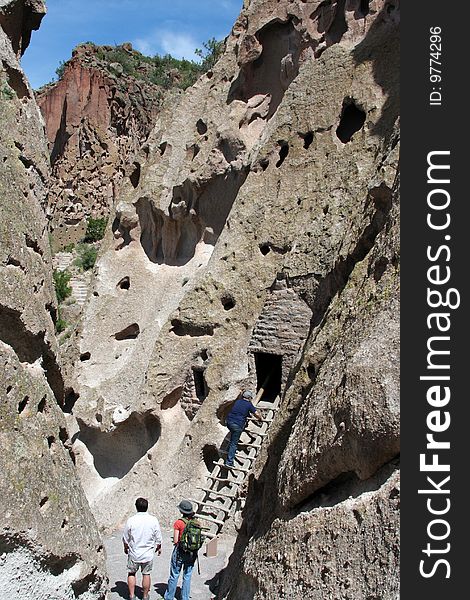 Visitors explore the mountains at Bandelier in New Mexico, the site of ancient Native American cliff dwellings.