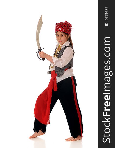 An elementary girl dresses as a pirate looking at the viewer with her sword drawn. Isolated on white. An elementary girl dresses as a pirate looking at the viewer with her sword drawn. Isolated on white.