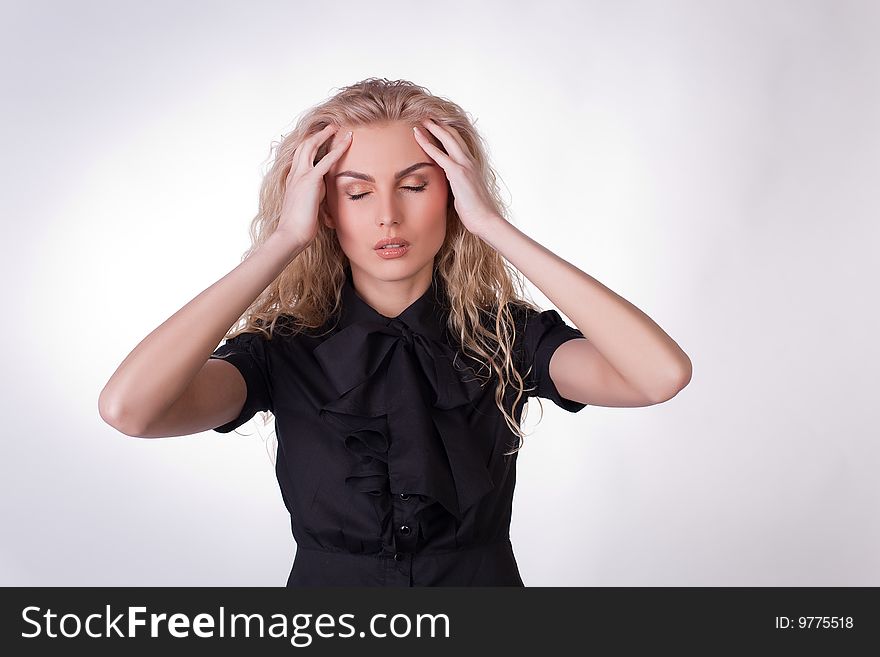 Girl with a headache, studio shot