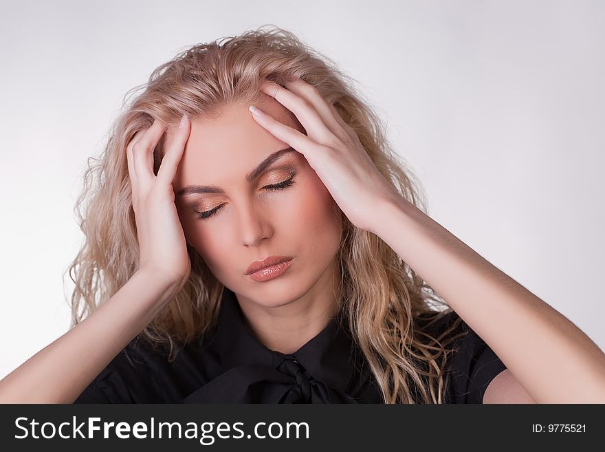 A shot of a girl with a headache, studio shot