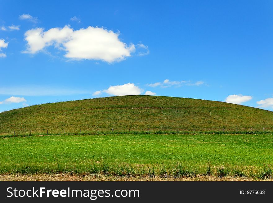 A hill with a green meadow and blue sky, Baden-Wuerttemberg, Germany