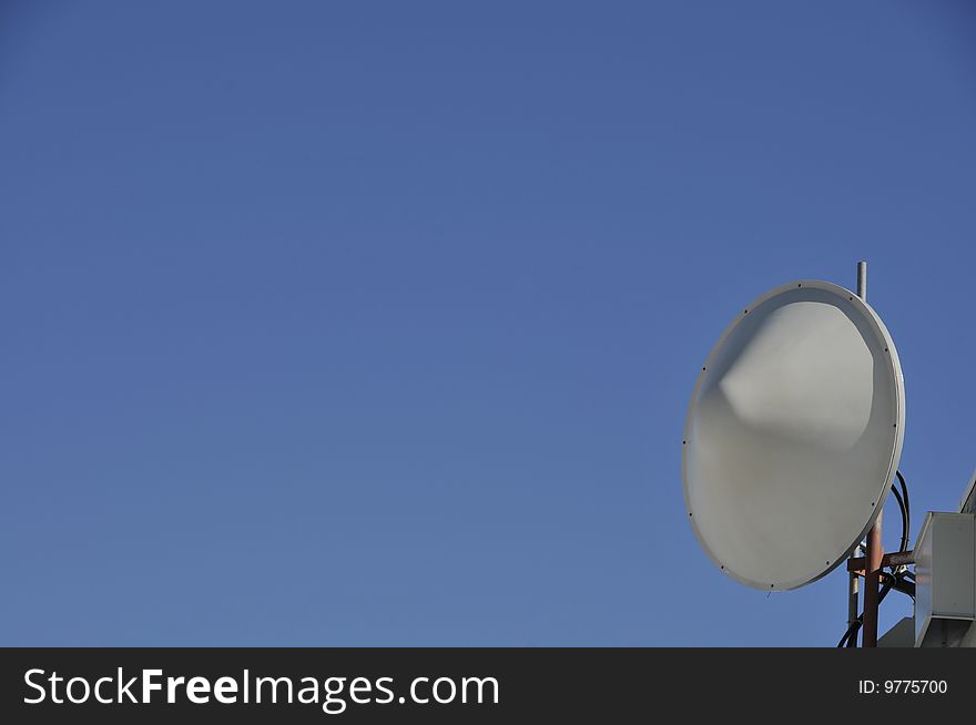 Remote Microwave Antenna on Top of Mountain Peak Against Blue Sky. Remote Microwave Antenna on Top of Mountain Peak Against Blue Sky