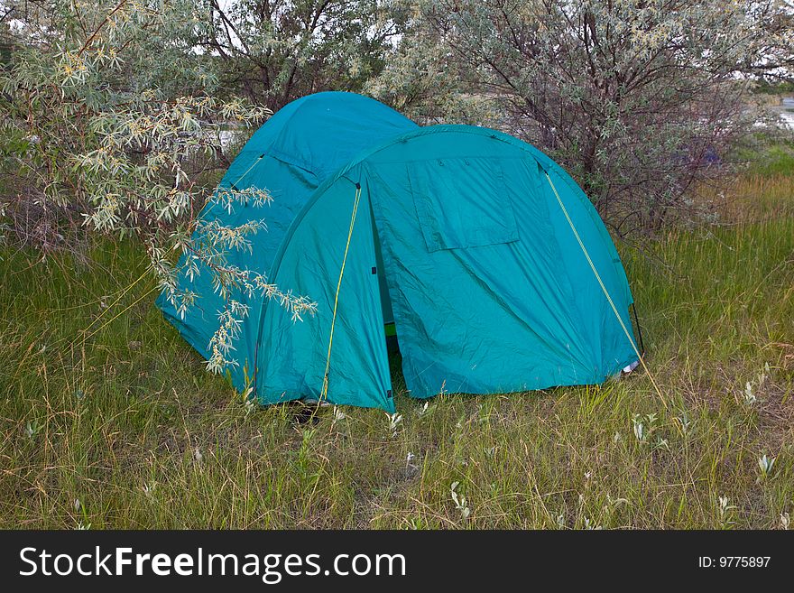 Tourist tent on a clearing in wood