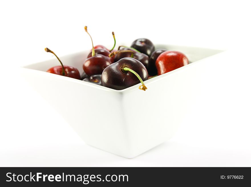 Bowl of cherries on a white background with clipping path