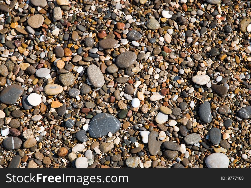 Pebbles on a beach as background. Pebbles on a beach as background