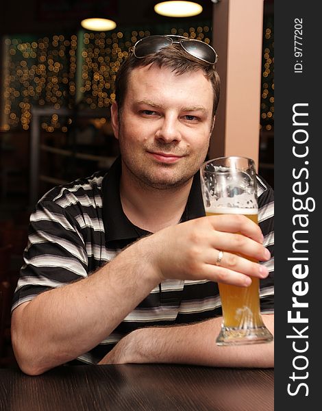 The man resting with beer in a bar. The man resting with beer in a bar