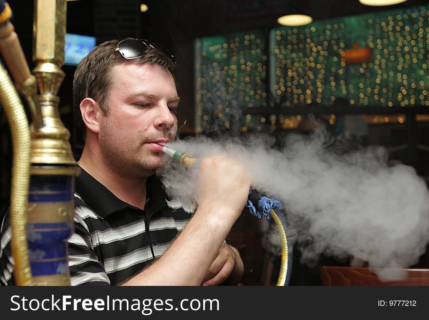 The man resting in a hookah house. The man resting in a hookah house