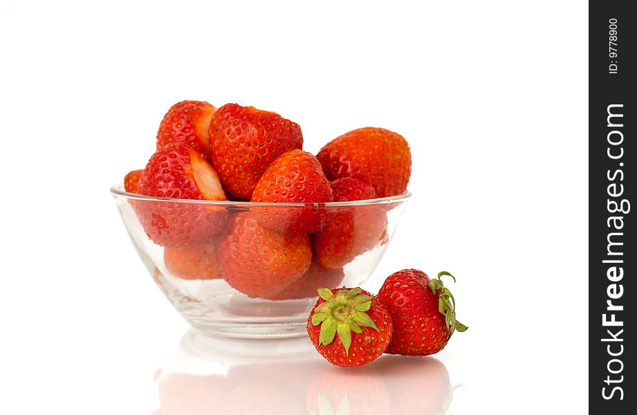 There is a lot of strawberries in glass dish.