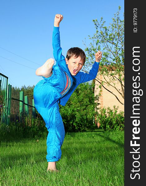 Karate kid in green grass outdoors