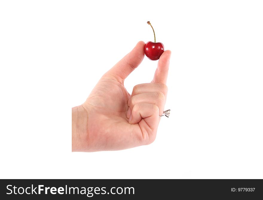 Hand holding a single cherry