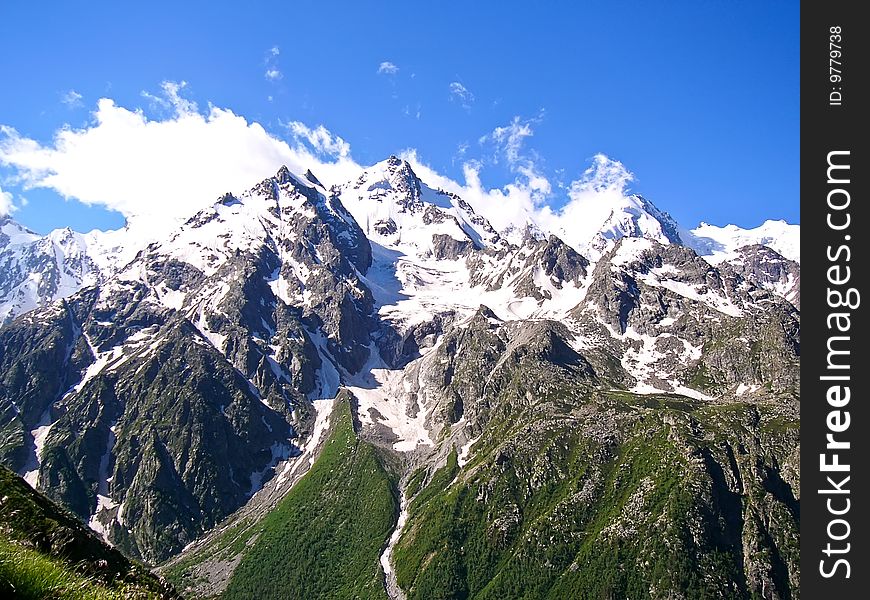 Snowy peaks of mountains in summer