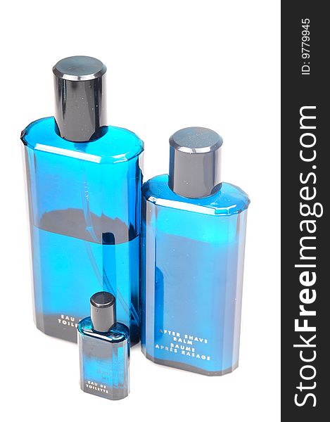 Blue bottles of perfume, after shave balm isolated on white background.