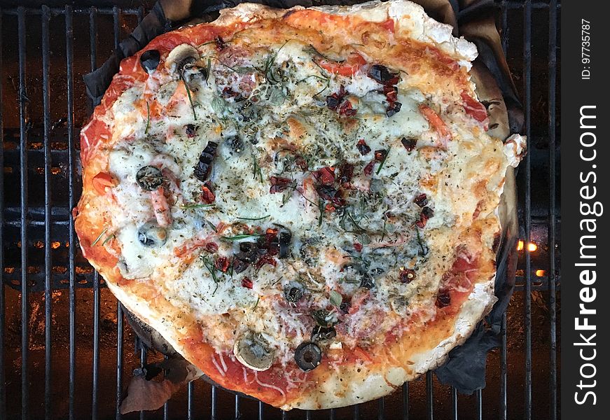 It&#x27;s the second dough of the batch, a little harder to work with. Red sauce with salami, mushroom, olive, red peppers. Topped with home dried red chili pepper and chives, oregano, thyme, rosemary, and basil from the garden. It&#x27;s the second dough of the batch, a little harder to work with. Red sauce with salami, mushroom, olive, red peppers. Topped with home dried red chili pepper and chives, oregano, thyme, rosemary, and basil from the garden