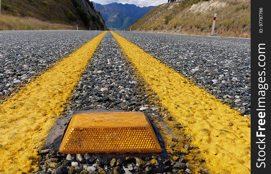 Yellow cat&#x27;s eyes, road studs or retroreflective raised pavement markers &#x28;RRPMs&#x29; are used to visually reinforce a yellow no-passing line. The painted passing line can be less visible when the road is wet. Usually a white cat&#x27;s eye is used in the centre of the road if overtaking is permitted. If yellow cat&#x27;s eyes are present they are bi-directional if the line is applicable in both directions, or mono-directional if it&#x27;s only applicable in one direction and spaced every 10m. On unlit rural roads the markers are in groups of four, one metre apart, with 10m between each group. Only one of the group of four road studs is required to be reflective. On no overtaking advance warning lines they are spaced 20m apart. The yellow cats eyes are the same kind as used in the UK or Australia and they are used in the same manner. Yellow cat&#x27;s eyes, road studs or retroreflective raised pavement markers &#x28;RRPMs&#x29; are used to visually reinforce a yellow no-passing line. The painted passing line can be less visible when the road is wet. Usually a white cat&#x27;s eye is used in the centre of the road if overtaking is permitted. If yellow cat&#x27;s eyes are present they are bi-directional if the line is applicable in both directions, or mono-directional if it&#x27;s only applicable in one direction and spaced every 10m. On unlit rural roads the markers are in groups of four, one metre apart, with 10m between each group. Only one of the group of four road studs is required to be reflective. On no overtaking advance warning lines they are spaced 20m apart. The yellow cats eyes are the same kind as used in the UK or Australia and they are used in the same manner.